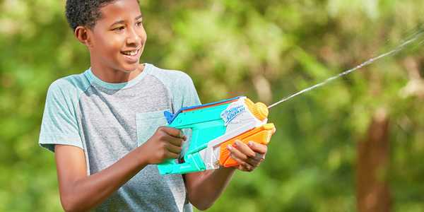 A boy squirting water from the Nerf Super Soaker splash mouth.